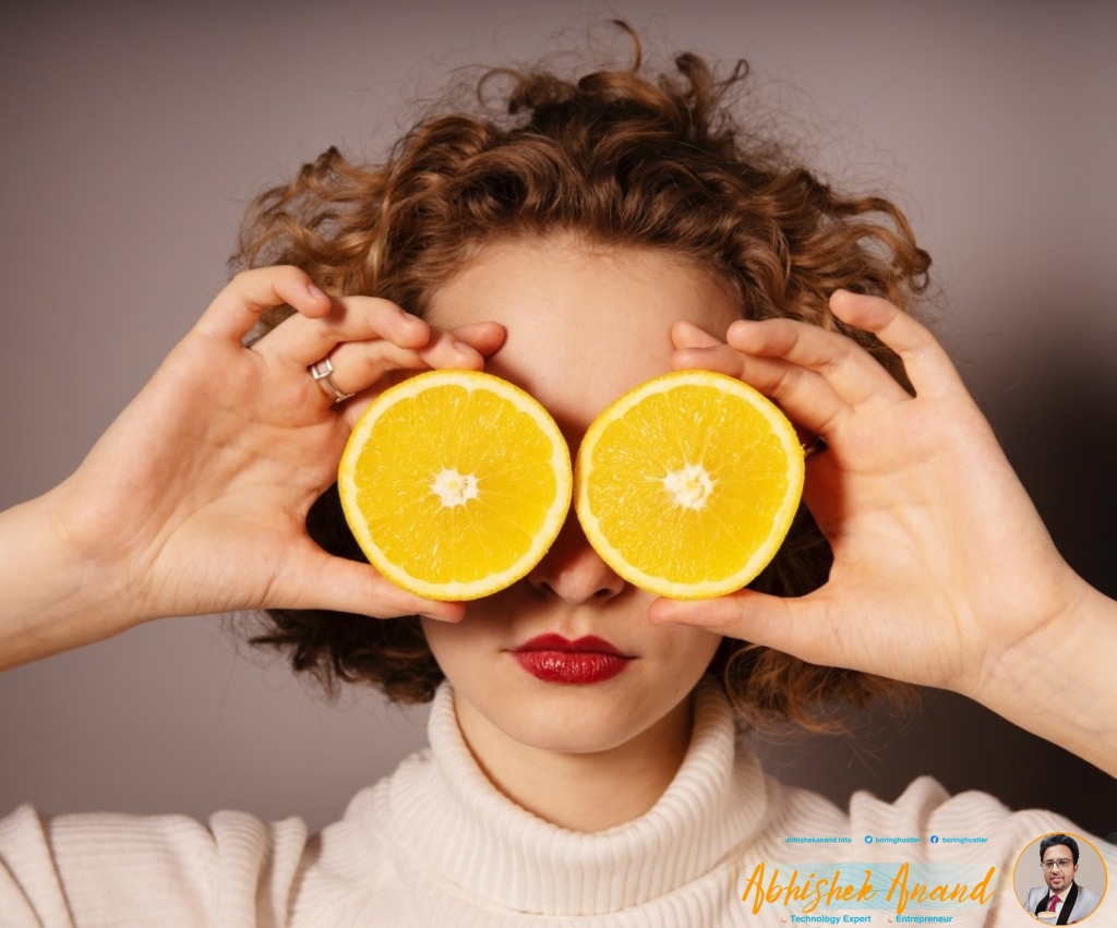 woman holding sliced orange fruit