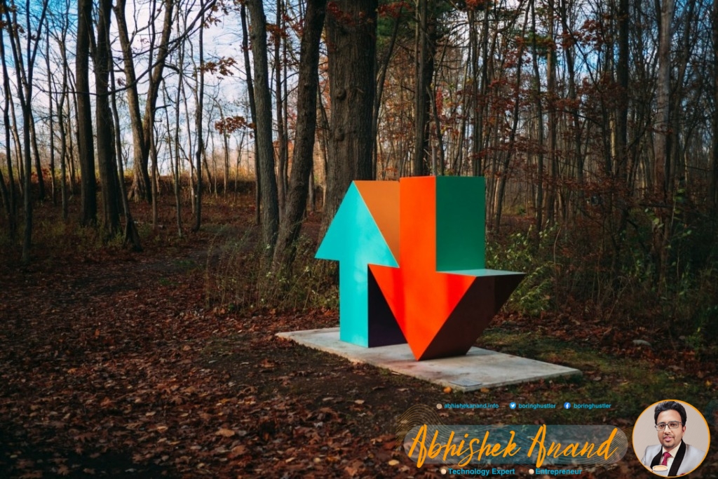 red and blue arrow sign surrounded by brown trees