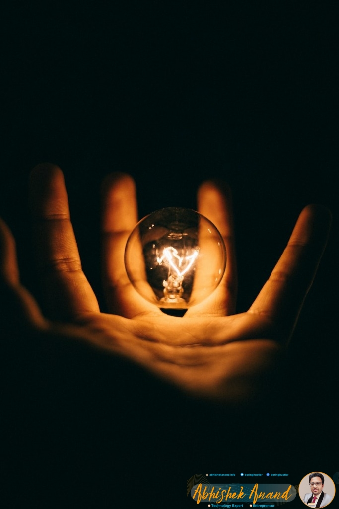 clear glass bulb on human palm