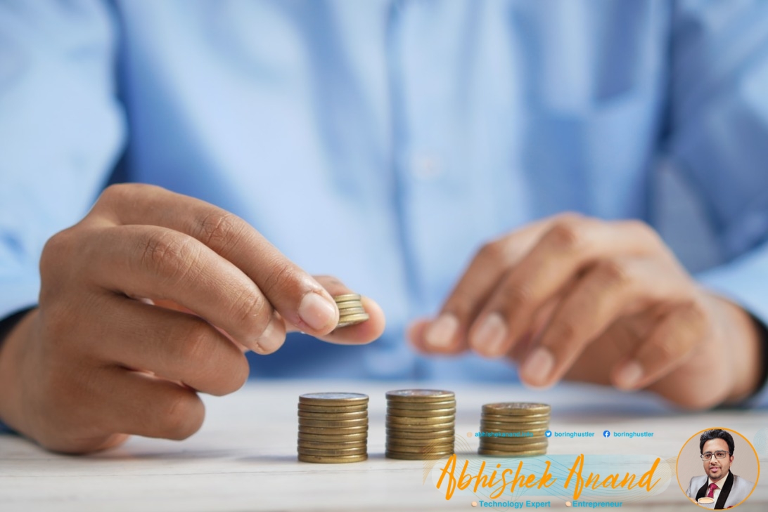 a person stacking coins on top of a table