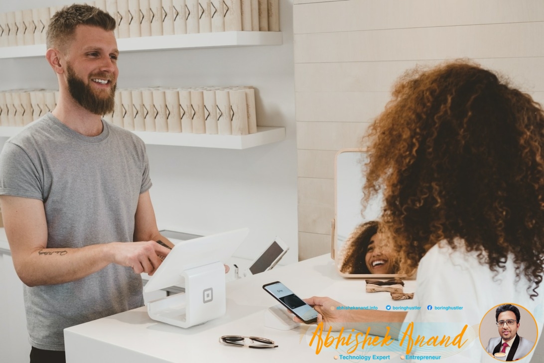 man in grey crew-neck t-shirt smiling to woman on counter