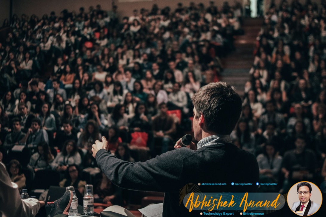 man speaking in front of crowd